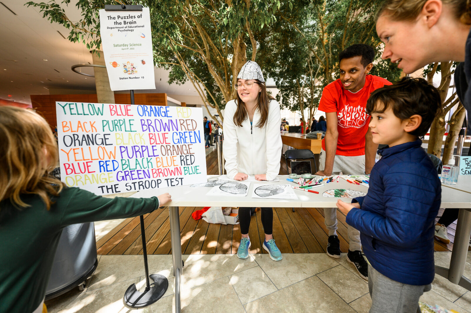 Children try the Stroop Color and Word Test, which is reading the names of colors written in ink of a different color, at a station on “The Puzzles of Brains”